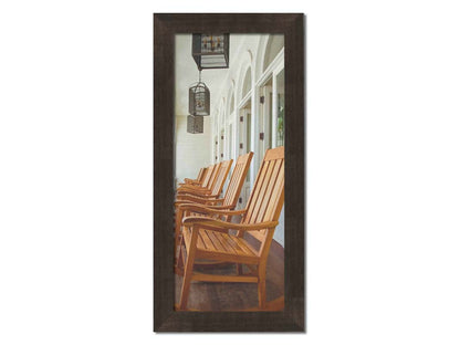 A photo looking down a row of rocking chairs on a porch in O'ahu, Hawaiʻi. Printed on canvas and framed.