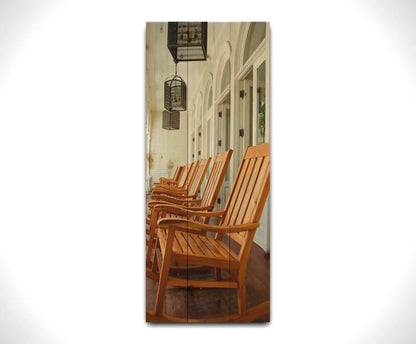 A photo looking down a row of rocking chairs on a porch in O'ahu, Hawaiʻi. Printed on a wood pallet.