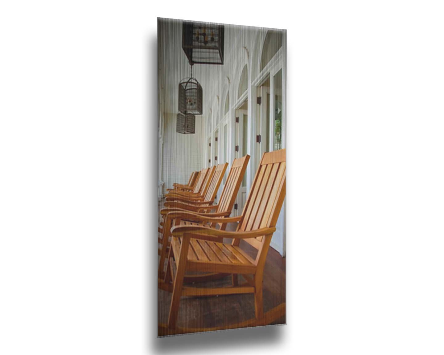 A photo looking down a row of rocking chairs on a porch in O'ahu, Hawaiʻi. Printed on metal.