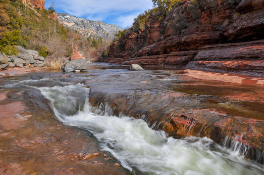 A photo of Slide Rock State Park in Sedona, Arizona, focusing on the iconic Oak Creek "natural waterslide."