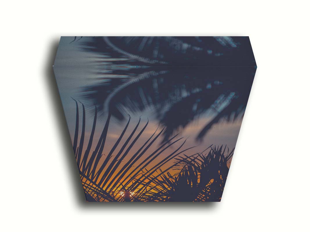 A photo of silhouetted palms at sunset. Printed on canvas.