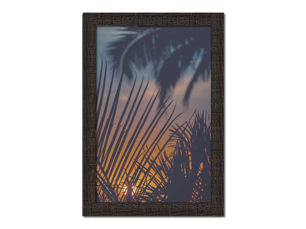 A photo of silhouetted palms at sunset. Printed on canvas and framed.