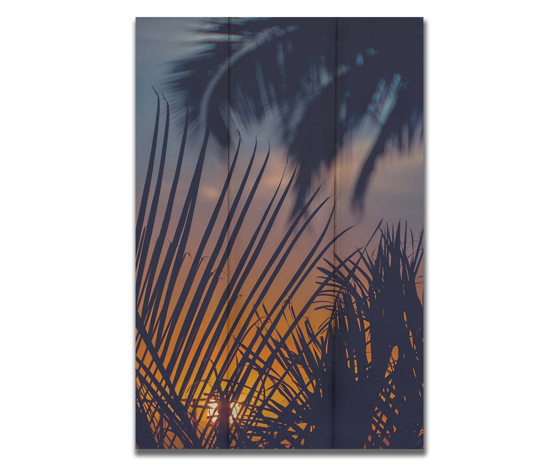 A photo of silhouetted palms at sunset. Printed on a box board.