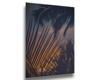 A photo of silhouetted palms at sunset. Printed on metal.