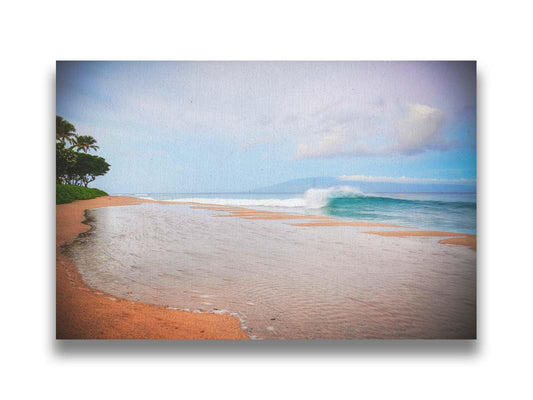 A refreshing photograph of Hawai'i's Ka'anapali beach, with cool blue waves rolling onto shore and mountains in the distance. Printed on canvas.