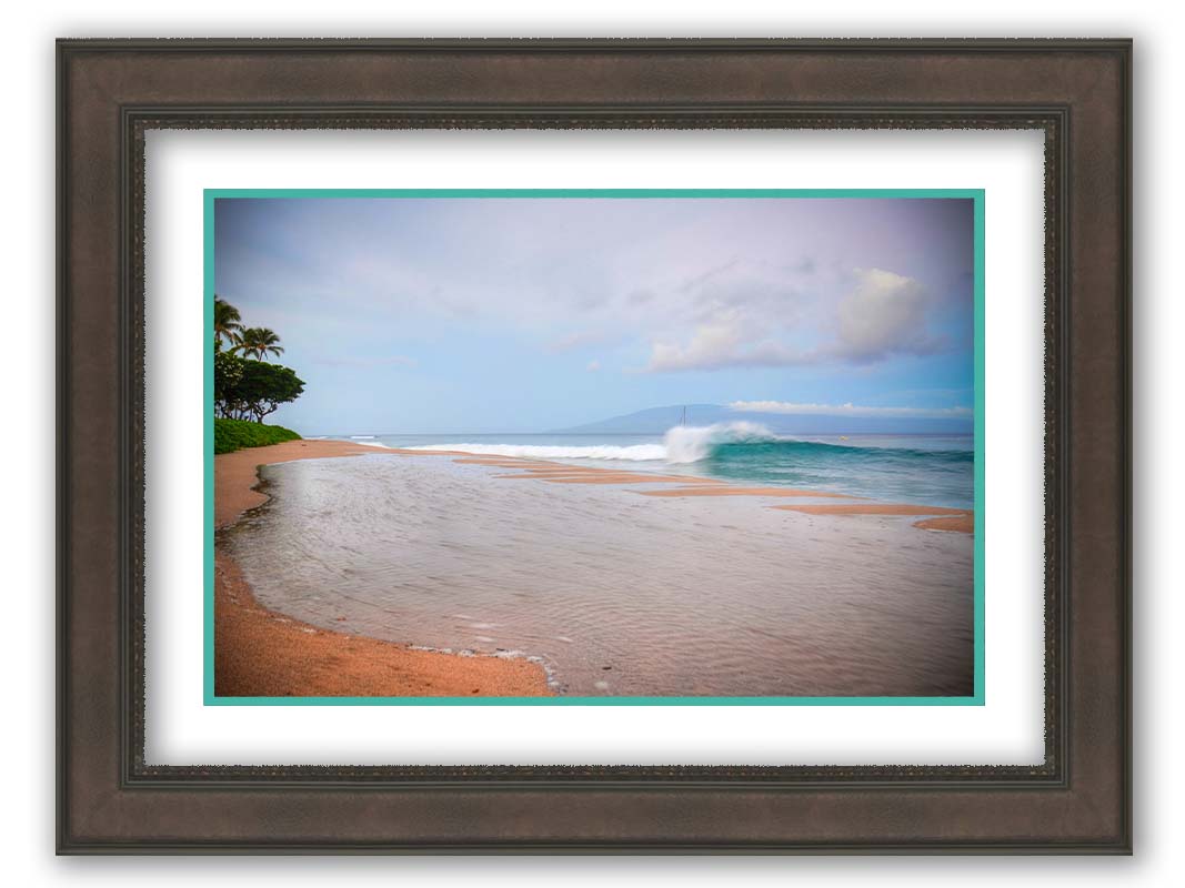 A refreshing photograph of Hawai'i's Ka'anapali beach, with cool blue waves rolling onto shore and mountains in the distance. Printed on paper, matted, and framed.