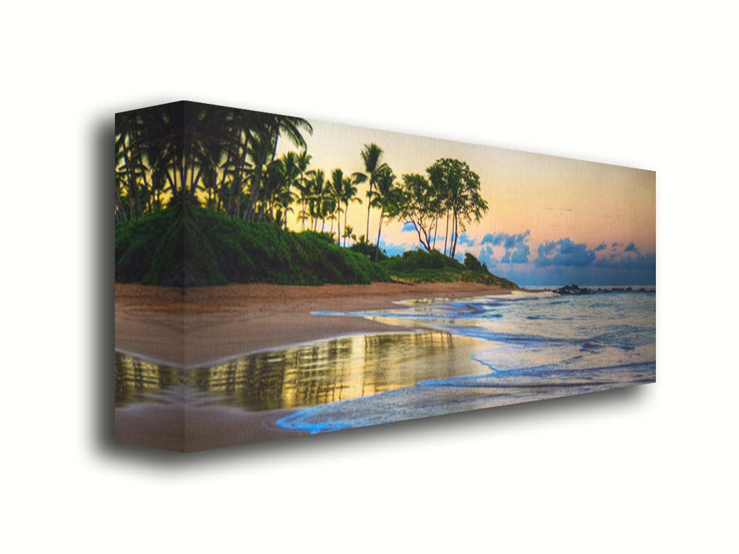 A photo of Keawakapu Beach at sunrise, with palms and mountains in the distance. Printed on canvas.