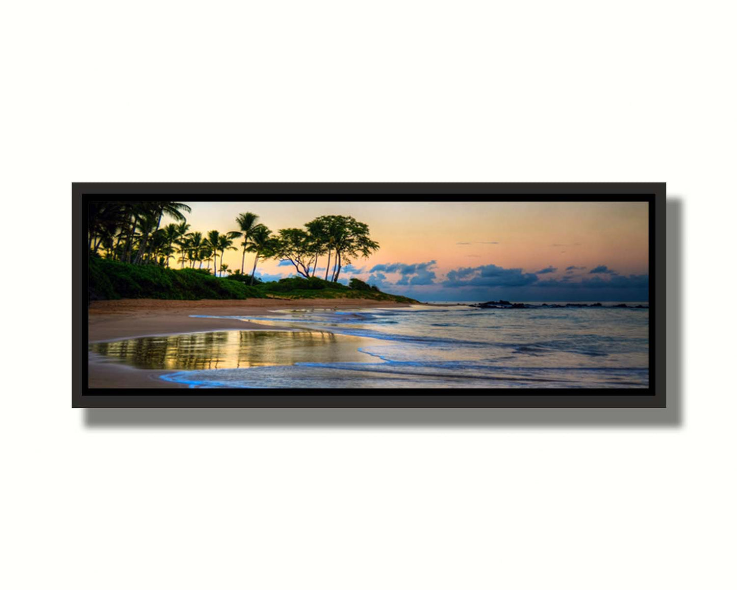 A photo of Keawakapu Beach at sunrise, with palms and mountains in the distance. Printed on canvas in a float frame.