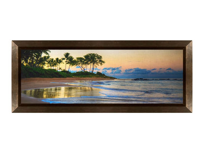 A photo of Keawakapu Beach at sunrise, with palms and mountains in the distance. Printed on canvas and framed.