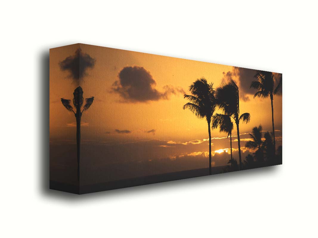 A photograph of an orange sunset over the sea, with striking palm trees silhouetted against the sky in Maui, Hawaiʻi. Printed on canvas.