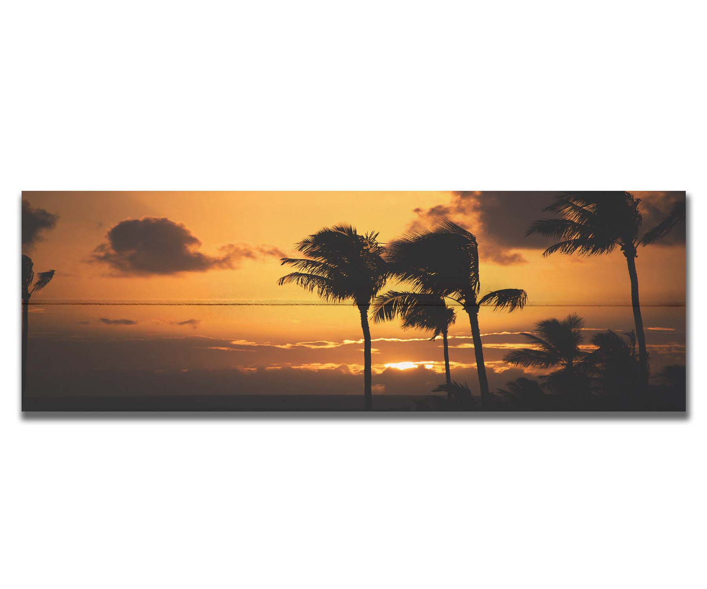 A photograph of an orange sunset over the sea, with striking palm trees silhouetted against the sky in Maui, Hawaiʻi. Printed on a box board.