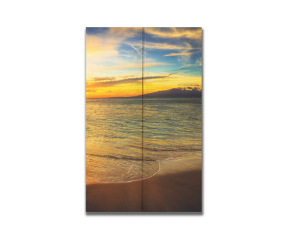 A photograph of a colorful sunset with a majestic mountain on the horizon, looking out over the sea on the coast of Maui, Hawaiʻi. Printed on a box board.