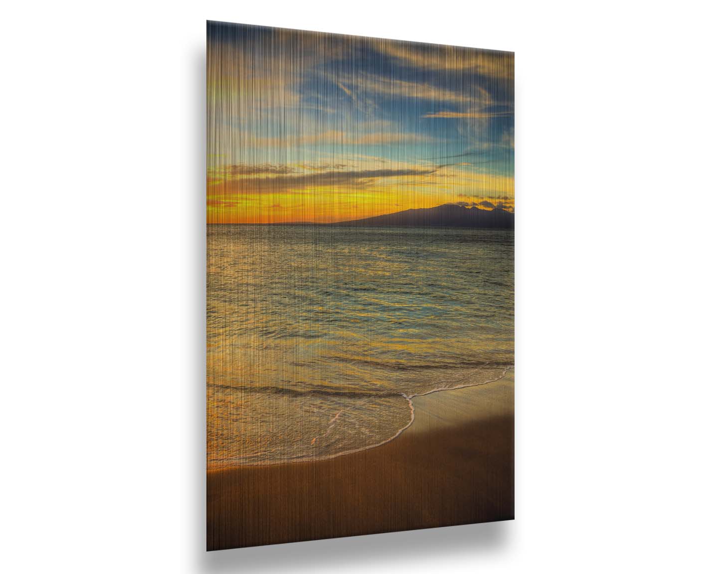 A photograph of a colorful sunset with a majestic mountain on the horizon, looking out over the sea on the coast of Maui, Hawaiʻi. Printed on metal.