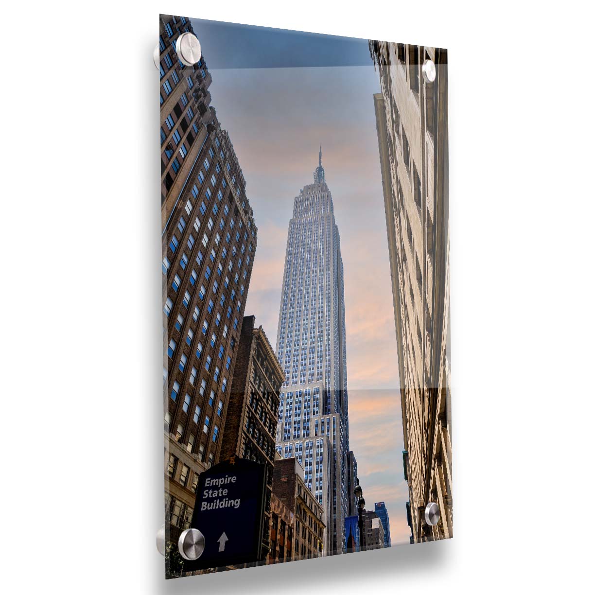 A photoraph looking up at the Empire State Building in New York against a blue sky and orange clouds. Printed on acrylic.