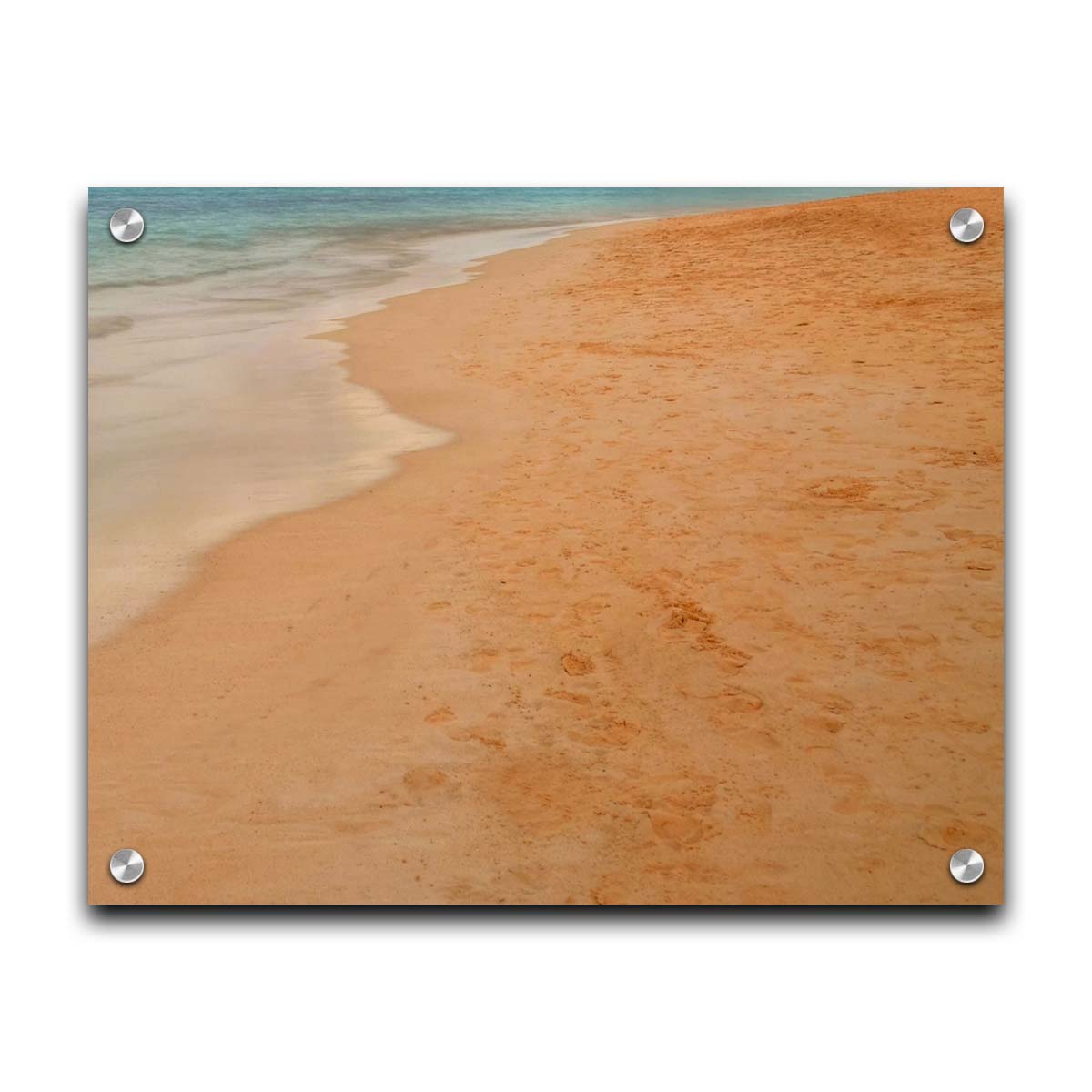 A photograph of beach sand. The warm hues of golden sand are contrasted by the cool ocean water. Printed on acrylic.