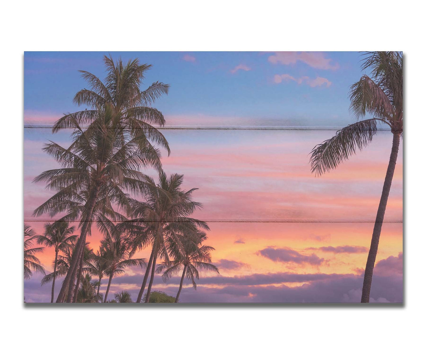 A photograph of Hawaiʻian palm trees, backed by a sunset sky in orange, pink, and blue. Printed on a box board.