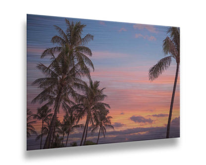 A photograph of Hawaiʻian palm trees, backed by a sunset sky in orange, pink, and blue. Printed on metal.