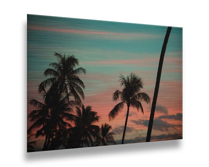 A photograph of Hawaiʻian palm trees, sihouetted against a sunset sky in orange, pink, and blue. Printed on metal.