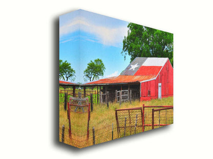 A photograph of a red barn, with a Texas flag painted on the roof. It is surrounded by red ranch fences and grassy fields. Printed on canvas.