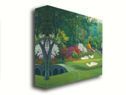 A painting of the Augusta Nationals golf course in Georgia. The course is encircled by foliage and flowers of all colors, and a bridged stream uns through the center. A few golfers stand near a small sand pit, lining up a shot to the nearby hole. Printed on canvas.