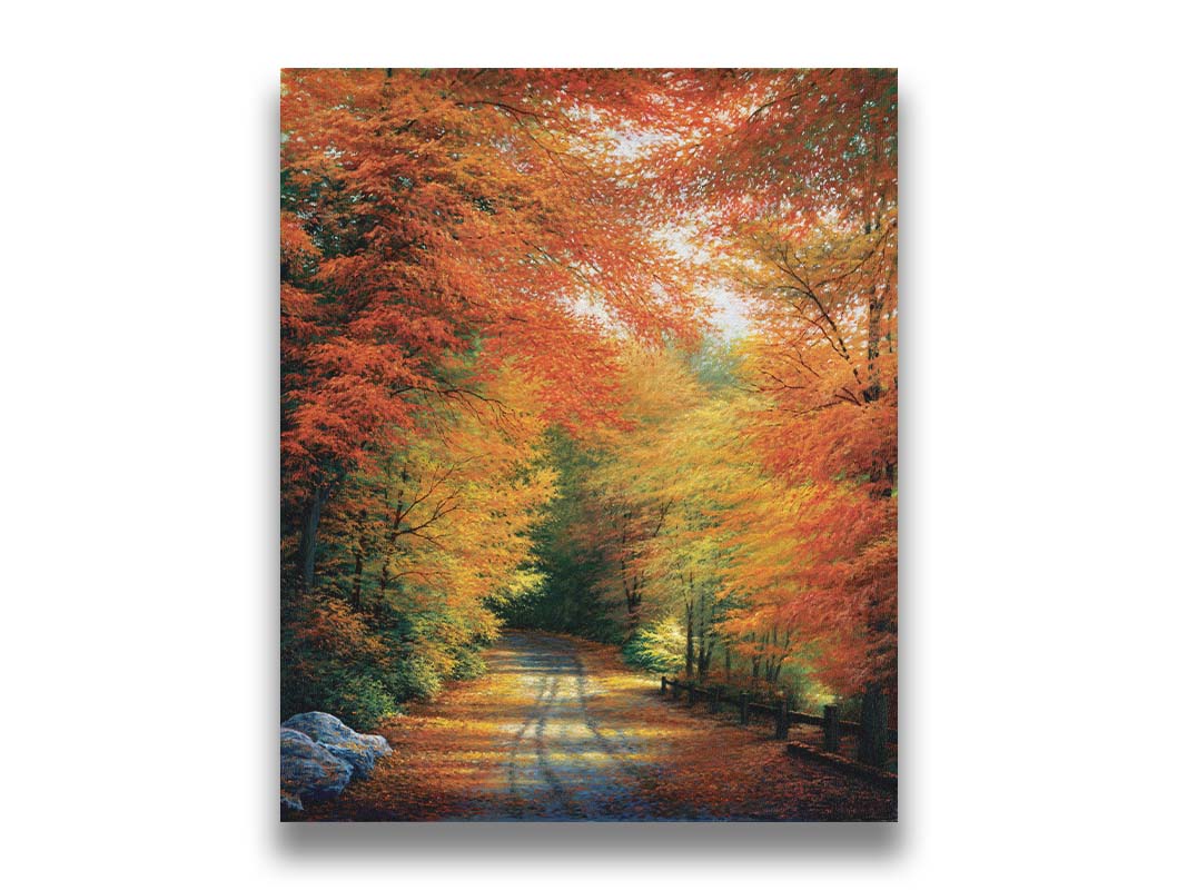 A painting of a road winding through a forest during fall. The red, orange, and yellow leaves shed to the ground, lining the road. Printed on canvas.