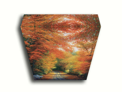 A painting of a road winding through a forest during fall. The red, orange, and yellow leaves shed to the ground, lining the road. Printed on canvas.