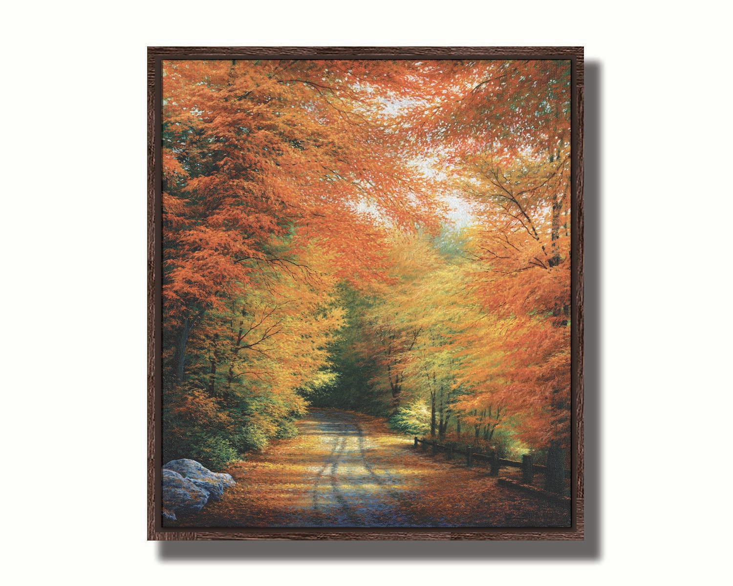 A painting of a road winding through a forest during fall. The red, orange, and yellow leaves shed to the ground, lining the road. Printed on canvas in a float frame.