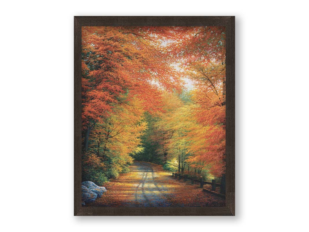 A painting of a road winding through a forest during fall. The red, orange, and yellow leaves shed to the ground, lining the road. Printed on canvas and framed.