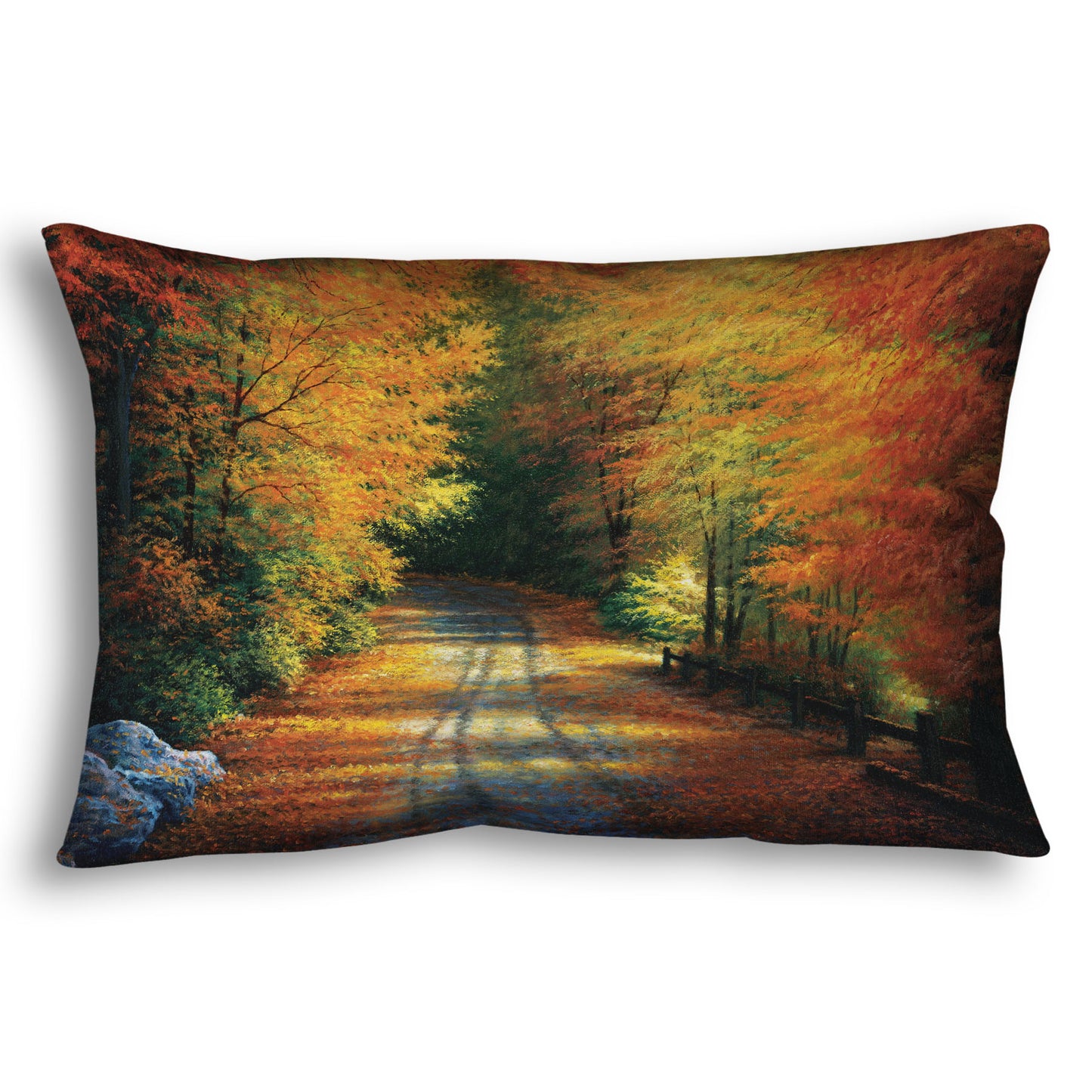 Decorative pillow with a painted autumn forest design. Red, orange, and yellow trees line a road winding through the forest.