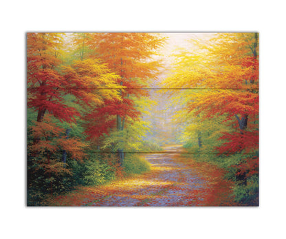 A painting of a road winding through a forest during fall. The green, yellow, red, and orange foliage and trees shed leaves that line the path. Printed on a box board.