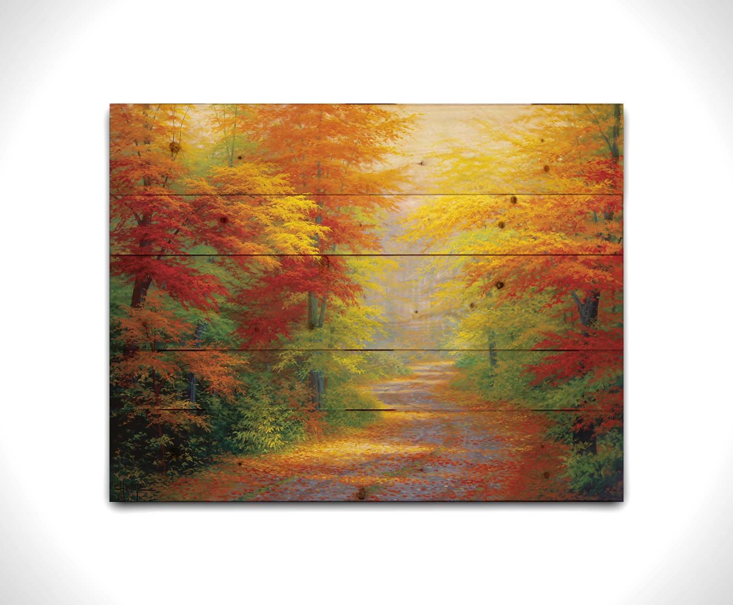 A painting of a road winding through a forest during fall. The green, yellow, red, and orange foliage and trees shed leaves that line the path. Printed on a wood pallet.