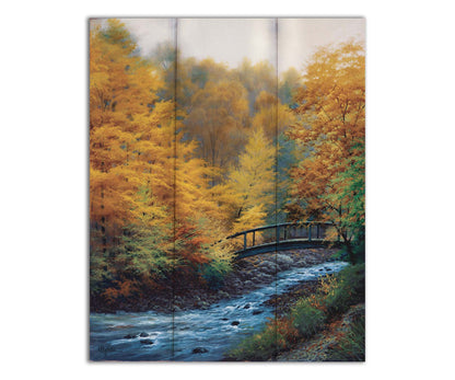 A painting of a forest stream, passing under an arched bridge. The trees are changing to yellow and orange for the fall season. Printed on a box board.