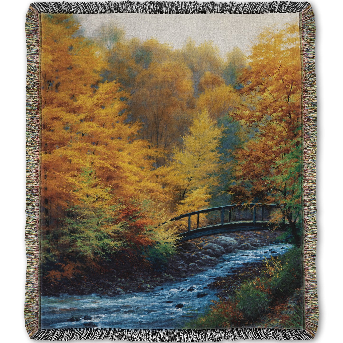 Woven throw blanket designed with a painting of a forest stream, passing under an arched bridge. The trees are changing to yellow and orange for fall.