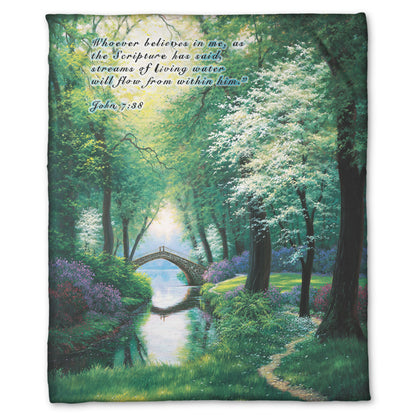 Coral fleece blanket designed with a painting of a stream through a lush green forest trail, with a bridge crossing in the distance.