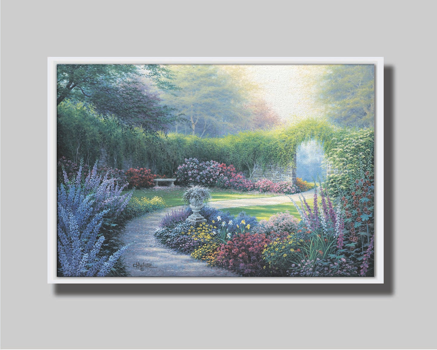 A painting of a serene path through a garden filled with bushes of flowers bathed in a gentle light. Printed on canvas in a float frame.