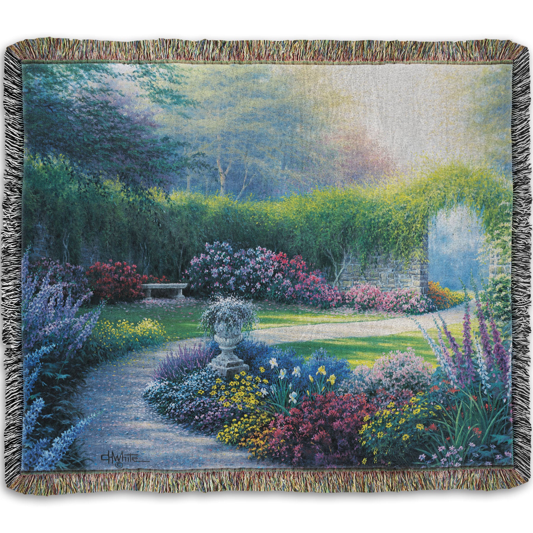 A woven blanket designed with a painting of a serene path through a garden filled with bushes of flowers bathed in a gentle light.