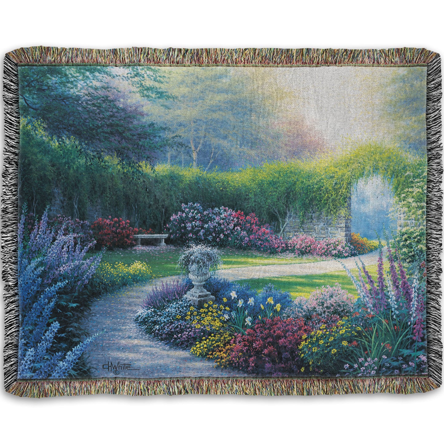 A woven blanket designed with a painting of a serene path through a garden filled with bushes of flowers bathed in a gentle light.