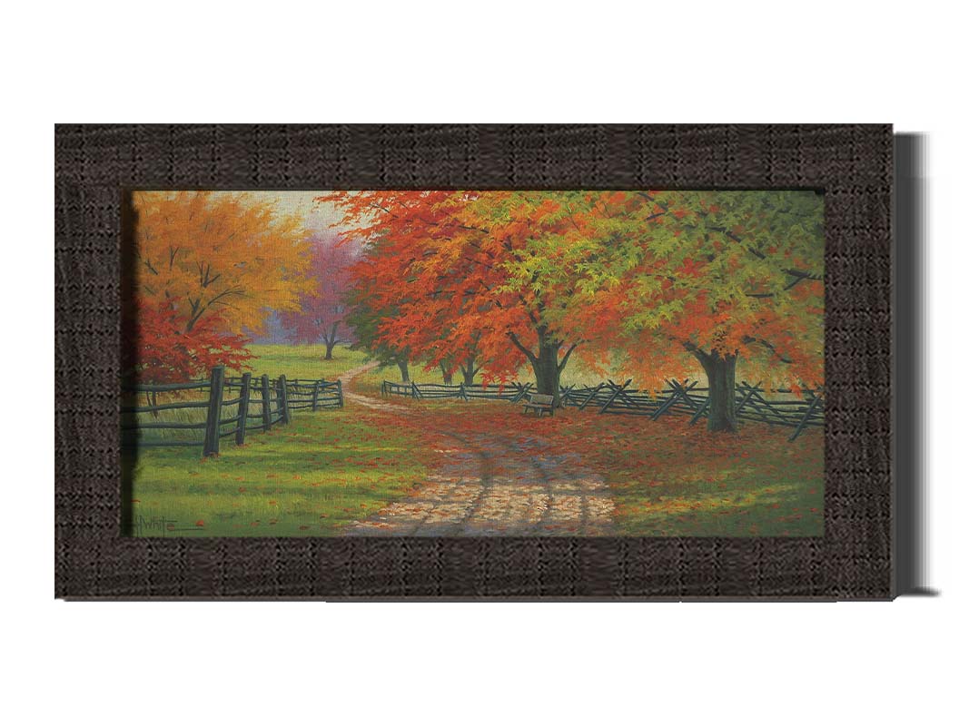 A painting of a road winding through a fenched field, surrounded by multicolor fall maple trees. Printed on canvas and framed.