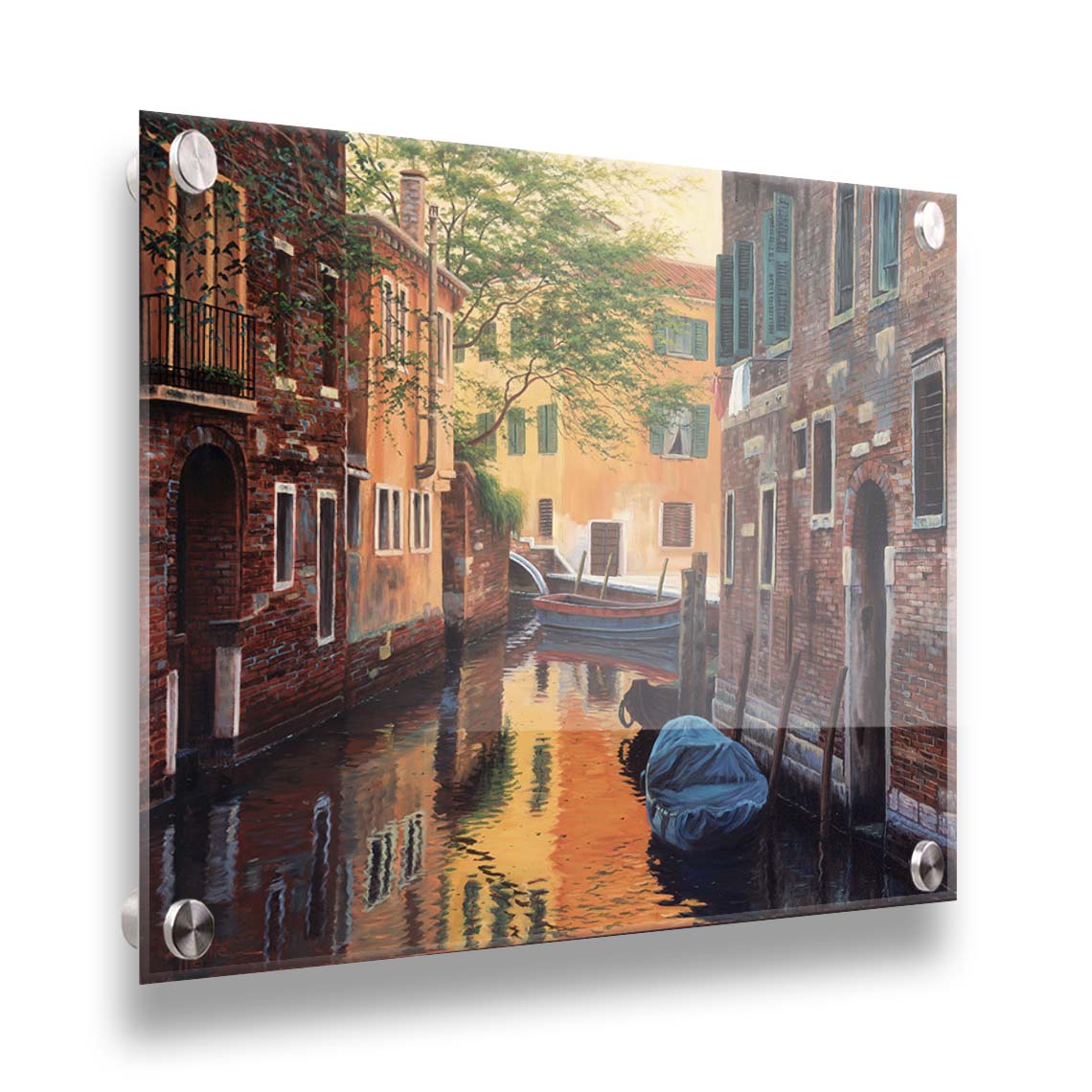 A painting of a canal alleyway between old brick buildings in Venice, Italy, during the day. The buildings reflect off the water in which a few small wood boats float. Printed on acrylic.