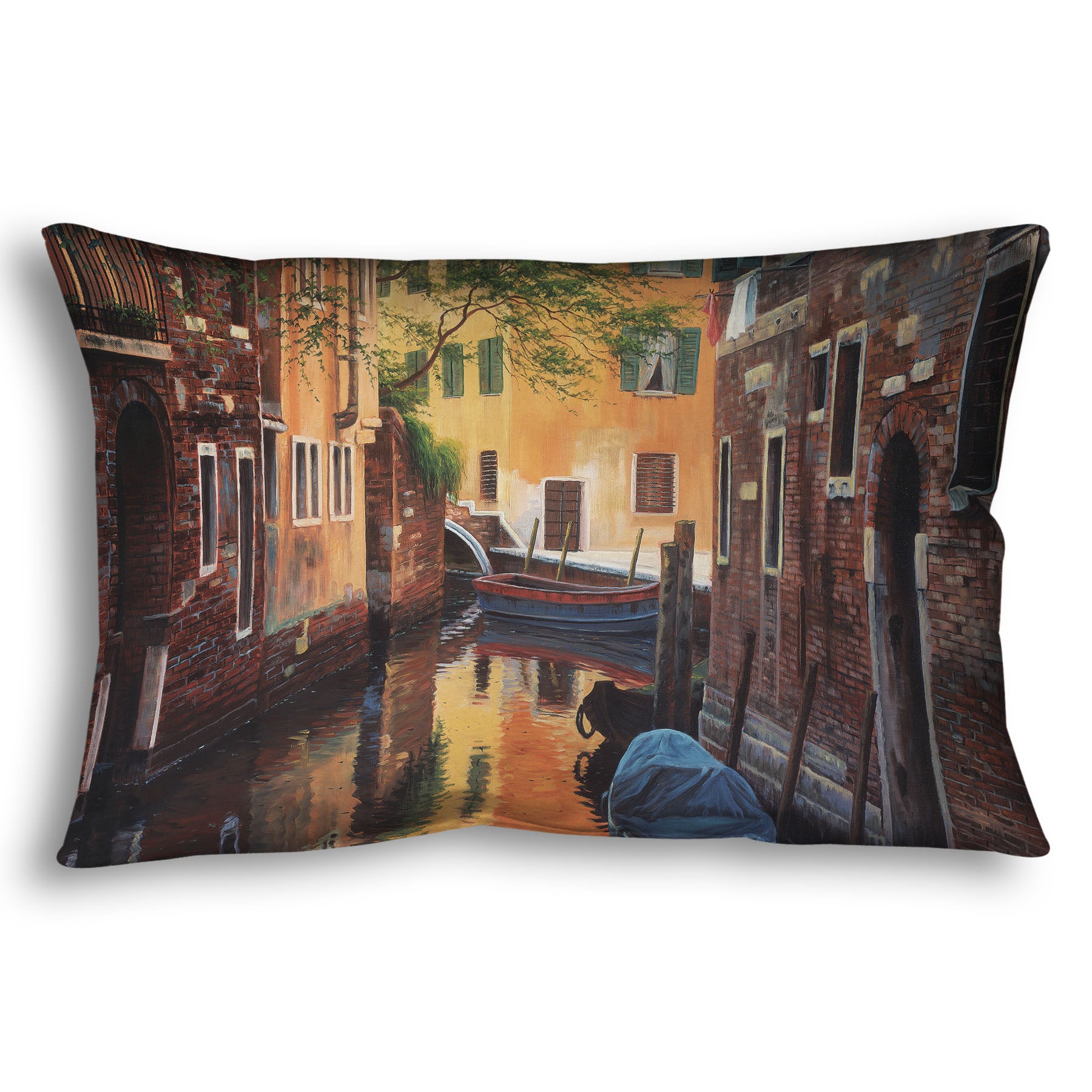 A throw pillow designed with a painting of a canal alleyway between old brick buildings in Venice, Italy, during the day. The buildings reflect off the water in which a few small wood boats float.