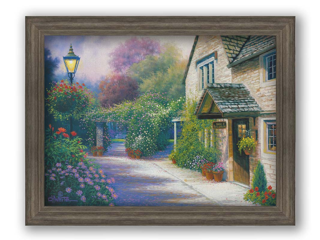 A painting of a bed and breakfast storefront, with a streetlamp-lined path leading to the garden full of blooming flowers. Printed on canvas and framed.