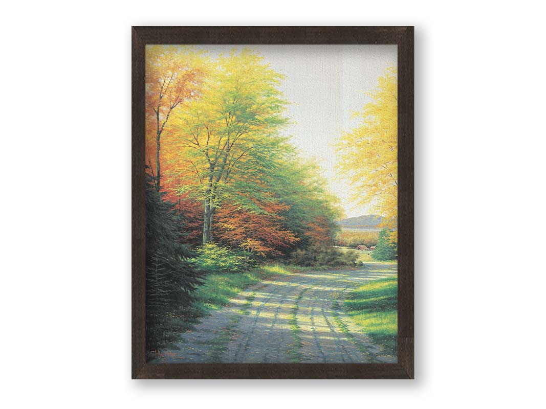 A painting looking down a country road, lined with both deciduous and coniferous trees. Several of the trees' leaves have turned orange and yellow due to the fall season. Printed on canvas and framed.