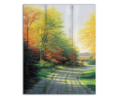 A painting looking down a country road, lined with both deciduous and coniferous trees. Several of the trees' leaves have turned orange and yellow due to the fall season. Printed on a box board.