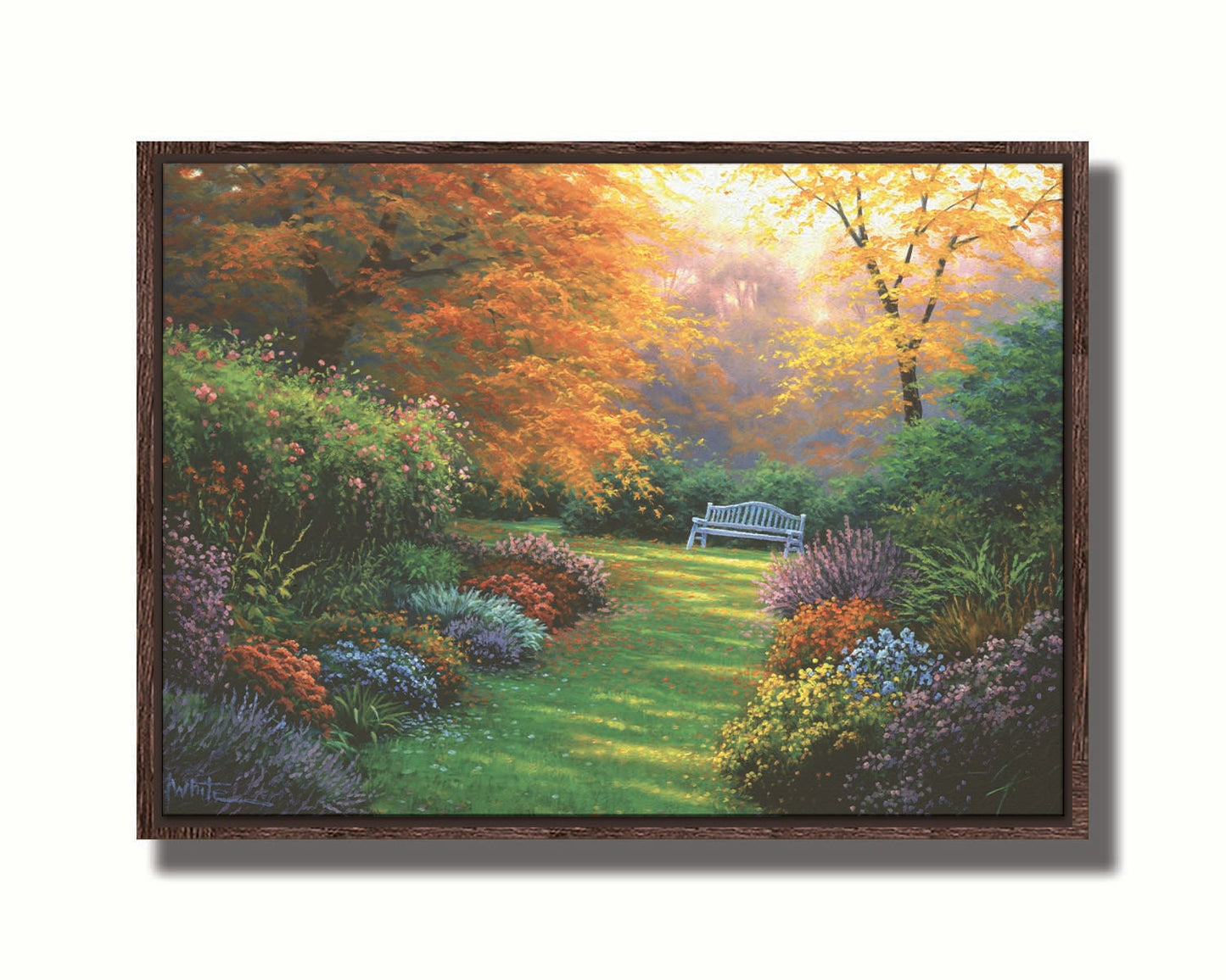 A painting of a garden path during fall. The trees surrounding the garden have turned orange and yellow. A grassy path through the garden is surrounded by bushes of flowers in every color, and a bench can be seen up ahead. Printed on canvas in a float frame.