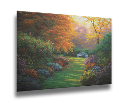 A painting of a garden path during fall. The trees surrounding the garden have turned orange and yellow. A grassy path through the garden is surrounded by bushes of flowers in every color, and a bench can be seen up ahead. Printed on metal.