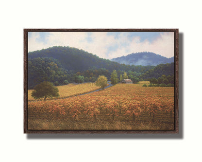 A painting of expansive vineyard fields, turned yellow, red, and orange for the fall. Rolling hills of forests fill the background. Printed on canvas in a float frame.