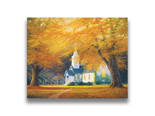 A painting of a white church in a forest of yellow and orange trees. Deer roam in the leaf-coated yard, and sun beams shine through the trees to highlight the building. Printed on canvas.