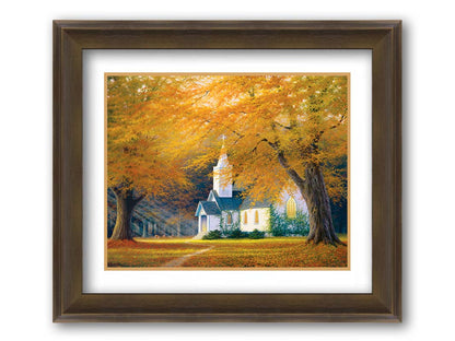 A painting of a white church in a forest of yellow and orange trees. Deer roam in the leaf-coated yard, and sun beams shine through the trees to highlight the building. Printed on paper, matted, and framed.