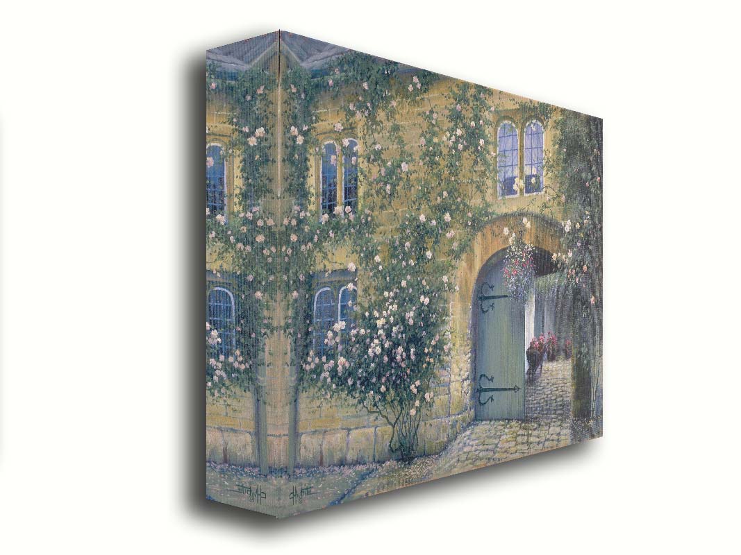 A painting of an arched doorway passing through a building into a courtyard. The building and courtyard are decorated with bushes and vines sprouting an assortment of white and red flowers. Printed on canvas.