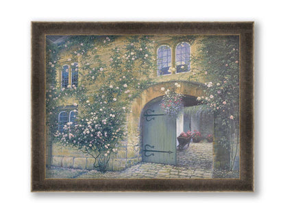 A painting of an arched doorway passing through a building into a courtyard. The building and courtyard are decorated with bushes and vines sprouting an assortment of white and red flowers. Printed on canvas and framed.